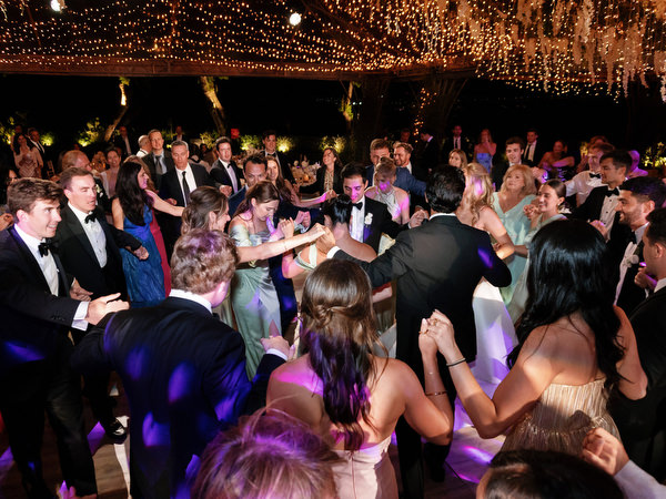 Guests surrounding bride and groom during high-energy dance floor moment at Island Resort Athens Riviera