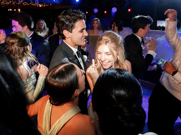 Bride and groom dancing in the middle of cheering guests during luxury Island Resort reception