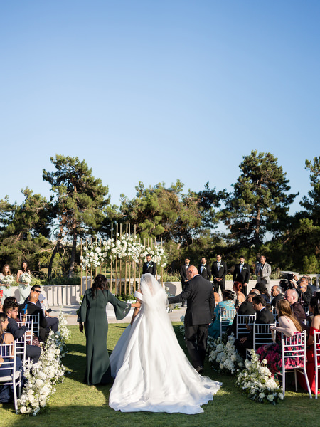 Bride walking down the aisle during symbolic wedding ceremony in Athens
