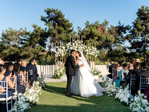 Bride and groom walking through ceremony aisle after wedding