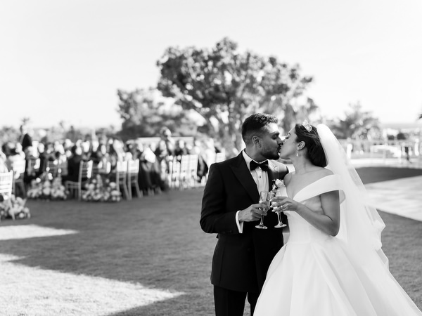 Black and white photo of bride and groom kissing after Athens Riviera wedding ceremony