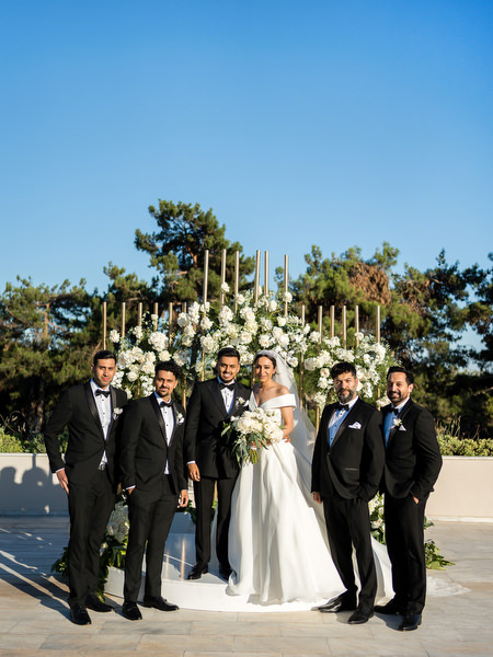 Couple portrait with groomsmen after ceremony