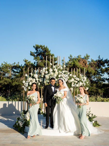 Couple portrait with bridesmaids after ceremony