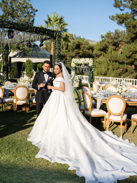 Couple portrait with reception setup in background near Athens Riviera
