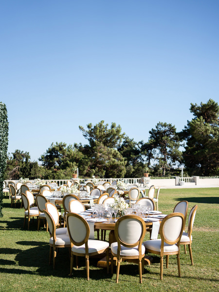 Wedding reception tables arranged on lawn at Golf Privé Glyfada wedding venue