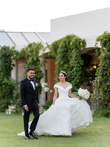 Couple walking through garden after ceremony at Golf Privé Glyfada
