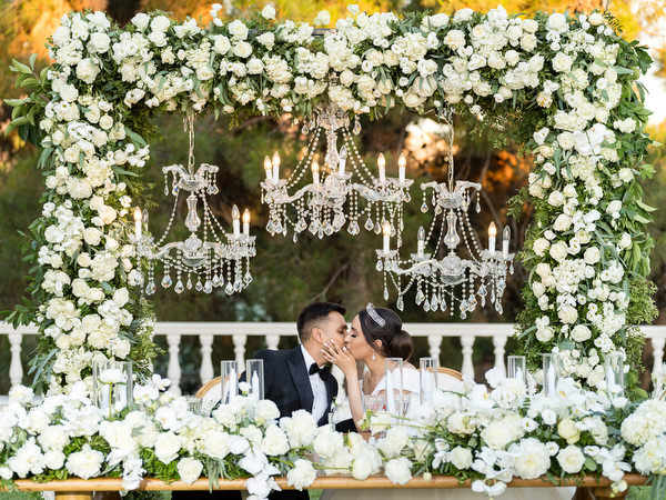 Bride and groom sharing romantic moment at reception tablet of Golf Privé Glyfada