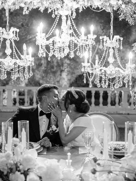 Couple kissing during evening wedding reception in Athens
