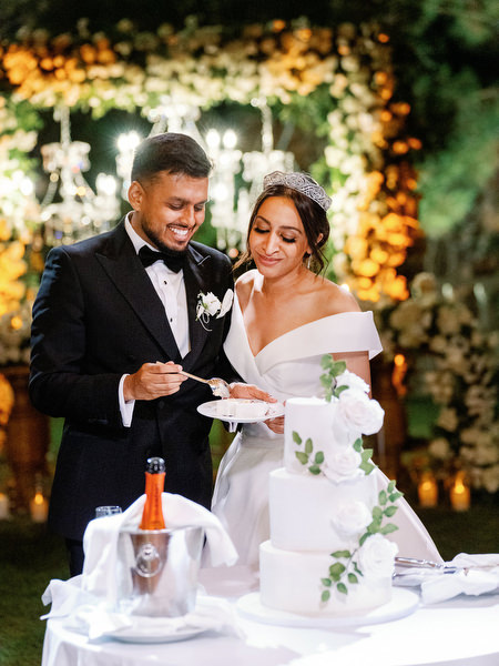 Romantic cake cutting under evening lights at Golf Privé Glyfada
