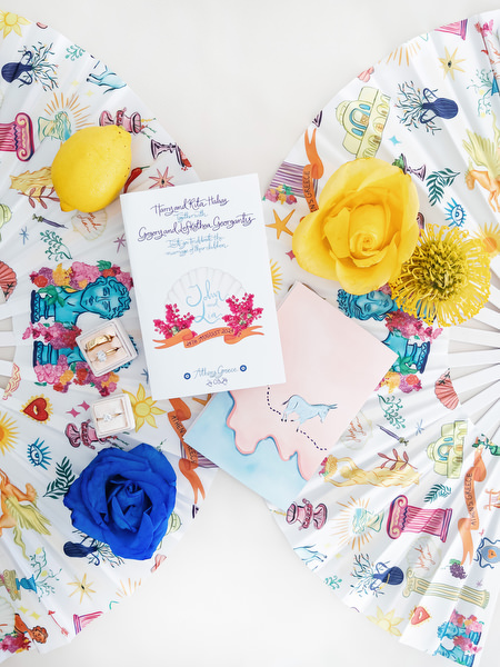 Custom illustrated wedding stationery with lemons, blue and yellow florals, and playful Greek-inspired design