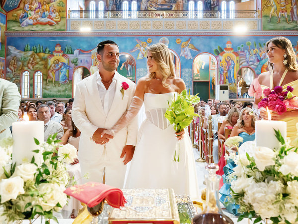 Bride and groom standing together during traditional Orthodox ceremony in Athens