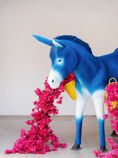 Bold blue donkey sculpture with cascading pink florals at high-fashion Athens Riviera wedding