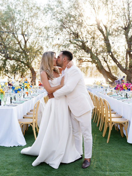 Bride and groom embracing during golden hour at outdoor Athens destination wedding