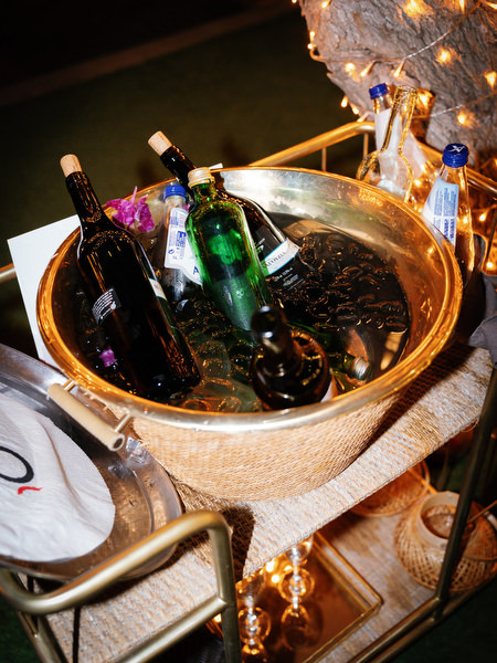 Champagne and spirits displayed in gold ice bowl during Athens Riviera reception