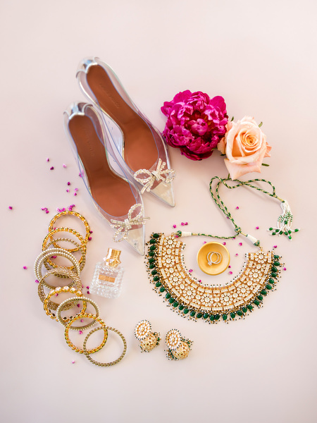 Indian bridal jewellery including gold necklace, bangles, perfume and heels styled for Hindu wedding at Private House Island Resort Athens Riviera.