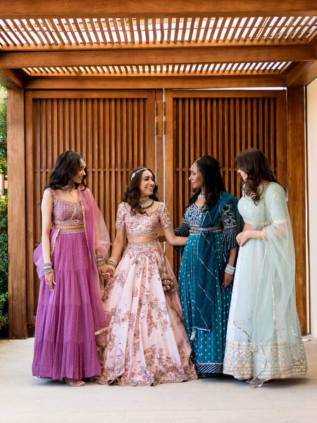 Bridal party in coordinated pastel Indian outfits at colourful Athens Riviera destination wedding.