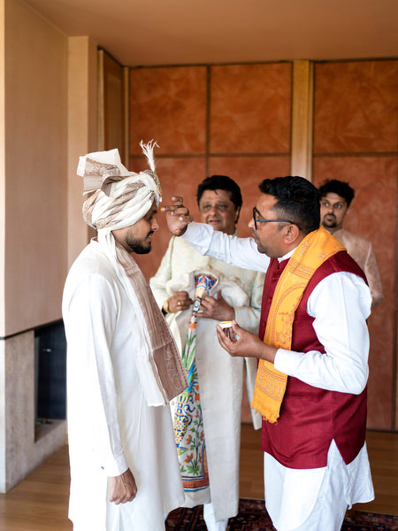 Groom during traditional Hindu pre-ceremony ritual at Private House Island Resort Athens Riviera.
