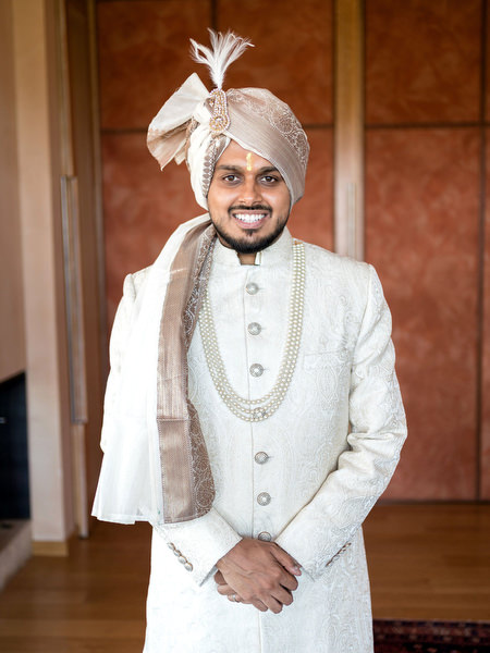 Groom portrait in ivory sherwani and turban at Margi Hotel Athens Riviera Hindu wedding.
