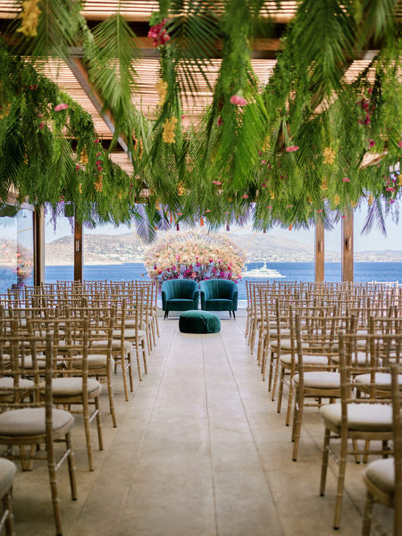 Hindu wedding ceremony setup with floral mandap overlooking the sea at Private House Island Resort Athens Riviera.