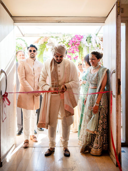 Traditional ribbon ceremony moment during Hindu wedding at Private House Island Resort Athens Riviera.