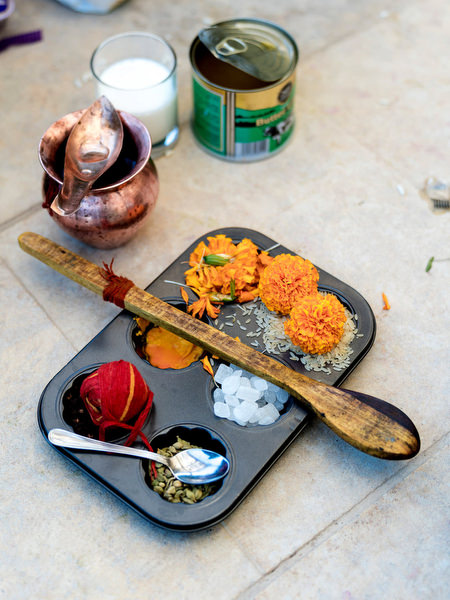 Hindu wedding ritual tray with marigolds, coconut and sacred items at Athens Riviera Indian wedding.