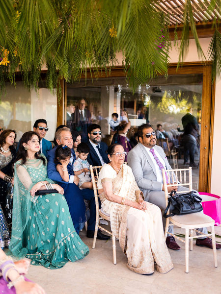 Guests seated under greenery canopy during Hindu wedding ceremony at Private House Island Resort Athens Riviera.