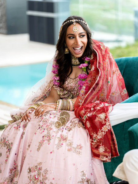 Bride laughing during Hindu wedding ritual at Private House Island Resort Athens Riviera ceremony.