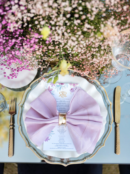 Luxury Indian wedding place setting with lilac napkin and monogram menu at Athens reception.