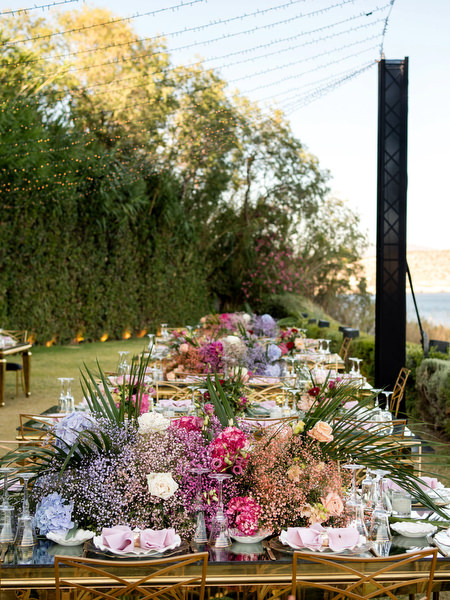 Luxury Indian wedding reception tables with colourful florals at Private House Island Resort Athens Greece.