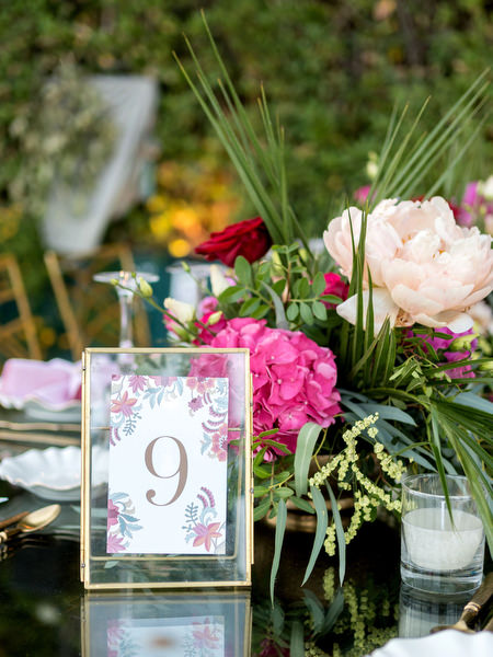 Floral table number card with pink and red blooms at Athens Indian destination wedding.
