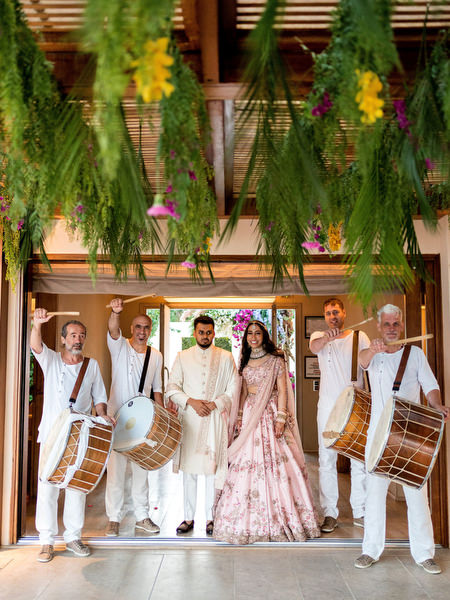 Traditional Indian dhol drummers entering reception at Private House Island Resort Athens Riviera wedding.