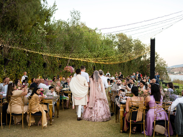 Guests seated at colourful Indian wedding reception tables at Private House Island Resort Athens.