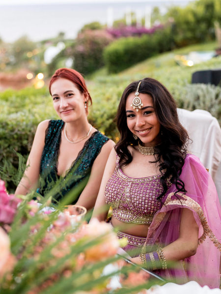 Guests seated at colourful Indian wedding reception tables at Private House Island Resort Athens.