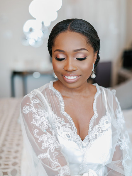 Close-up bridal portrait with elegant makeup during luxury Nigerian wedding preparation in Athens Greece.