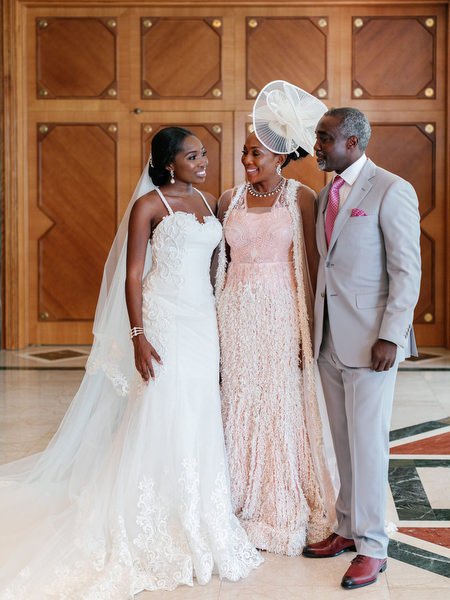 Bride with parents during luxury Nigerian wedding at The Margi Hotel on the Athens Riviera Greece.