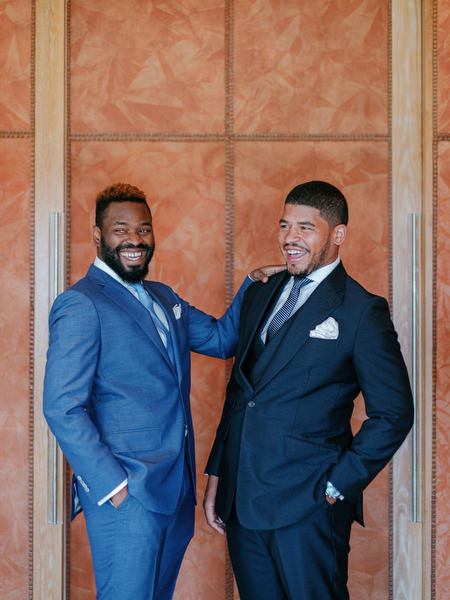 Groom with groomsman in tailored suits during luxury Nigerian wedding at The Margi Hotel Athens Riviera.