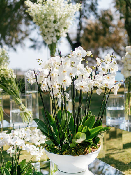 White orchid floral arrangement detail at Ble Azure ceremony during high-end Nigerian destination wedding in Athens.