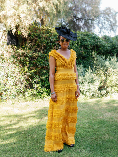 Female guest in couture yellow gown at Ble Azure ceremony during glamorous Nigerian wedding in Athens Riviera.