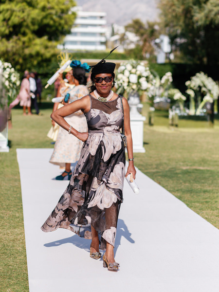 Elegant wedding guest walking down aisle at Ble Azure luxury Nigerian wedding ceremony in Greece.
