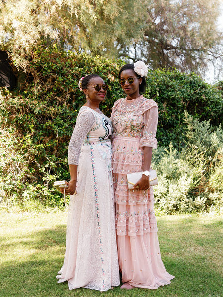 Female wedding guests in pastel gowns at Ble Azure during luxury Nigerian wedding ceremony in Athens.