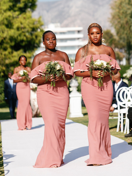 Bridesmaids walking ceremony aisle at Ble Azure luxury Nigerian destination wedding in Athens Riviera.