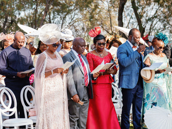 Guests seated at outdoor garden ceremony at Ble Azure during luxury Nigerian wedding on the Athens Riviera.