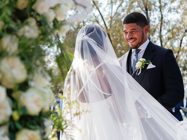 Bride and groom smiling during ceremony at Ble Azure luxury Nigerian wedding on the Athens Riviera.