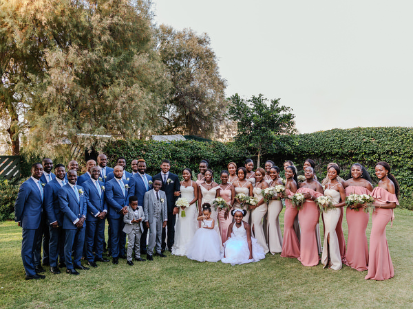 Large bridal party portrait at Ble Azure during luxury Nigerian destination wedding in Athens Greece.