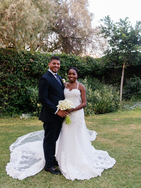 Bride and groom portrait on garden lawn at Ble Azure following luxury Nigerian wedding ceremony in Athens Greece.
