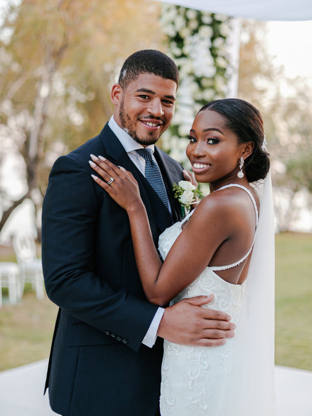 Bride and groom embracing at Ble Azure after luxury Nigerian wedding ceremony on the Athens Riviera.