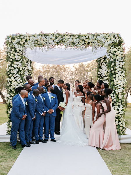 Groomsmen in blue suits and bridesmaids in blush gowns at Ble Azure ceremony portraits in Athens.