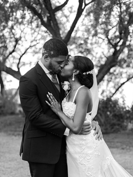 Black and white portrait of bride and groom embracing at Ble Azure luxury Nigerian wedding in Athens Greece.