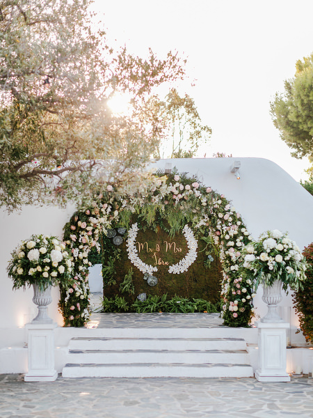 Floral stage backdrop with white and blush blooms at Island Resort The Residence luxury Nigerian wedding reception in Athens.