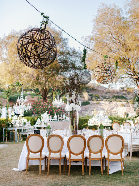 Woven hanging light installations above reception tables at Island Resort The Residence wedding in Athens Greece.